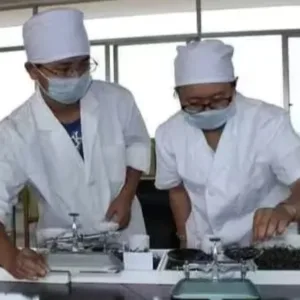 b2b 25 a couple of men wearing white coats and masks